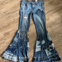 Load image into Gallery viewer, Upcycled from a collection of salvaged denim threads. Base jeans are from Adriano Goldshmied "The Stilt" womens size 28, and in excellent condition! Some give/stretch denim with intentional distress, and embroidered stitching over distressed areas. Added denim bits and pieces to create wide-flared bottoms.
Handcrafted with love and intention.
One-of-a-kind
Funky vibes
Size 28
Cold wash, like you would any pair of jeans, for longevity
Handmade in Santa Cruz, CA