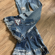 Load image into Gallery viewer, Upcycled from a collection of salvaged denim threads. Base jeans are from Adriano Goldshmied "The Stilt" womens size 28, and in excellent condition! Some give/stretch denim with intentional distress, and embroidered stitching over distressed areas. Added denim bits and pieces to create wide-flared bottoms.
Handcrafted with love and intention.
One-of-a-kind
Funky vibes
Size 28
Cold wash, like you would any pair of jeans, for longevity
Handmade in Santa Cruz, CA