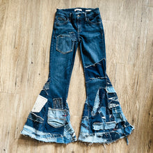 Load image into Gallery viewer, Upcycled from a collection of salvaged denim threads, including denim pants from a professional painter. Base jeans are from GUESS Womens size 27 fit, and in excellent condition! Some give/stretch denim with some intentional distress and random pockets. Added denim bits and pieces to create wide-flared bottoms. 