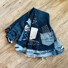 Load image into Gallery viewer, Upcycled from a collection of salvaged denim threads, including denim pants from a professional painter. Base jeans are from GUESS Womens size 27 fit, and in excellent condition! Some give/stretch denim with some intentional distress and random pockets. Added denim bits and pieces to create wide-flared bottoms. 