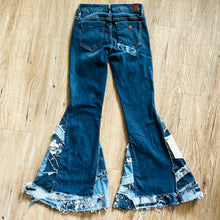 Load image into Gallery viewer, Upcycled from a collection of salvaged denim threads, including denim pants from a professional painter. Base jeans are from GUESS Womens size 27 fit, and in excellent condition! Some give/stretch denim with some intentional distress and random pockets. Added denim bits and pieces to create wide-flared bottoms. 