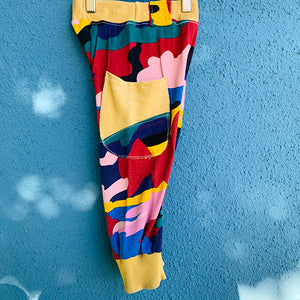 Upcycled from a super fun and colorful cotton tee! Cuffed bottoms, two pockets for all the magical finds, super comfortable and ready for play time! Handcrafted with love and intention.  One-of-a-kind Camo vibes Size 3T Handmade in Santa Cruz, CA