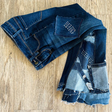 Load image into Gallery viewer, Upcycled from salvaged denim. Base jeans are from YMIGirl Kids size 7, in great condition! Stretch denim with some intentional distress. Added denim bits and pieces, sashiko stitching for detail and embellishment, medium-flared bottoms. 
Handcrafted with love and intention.
One-of-a-kind
Fresh vibes
Size 7
Cold wash, like you would any pair of jeans, for longevity
Handmade in Santa Cruz, CA