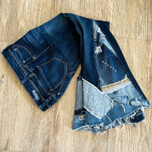 Load image into Gallery viewer, Upcycled from salvaged denim. Base jeans are from YMIGirl Kids size 7, in great condition! Stretch denim with some intentional distress. Added denim bits and pieces, sashiko stitching for detail and embellishment, medium-flared bottoms. 
Handcrafted with love and intention.
One-of-a-kind
Fresh vibes
Size 7
Cold wash, like you would any pair of jeans, for longevity
Handmade in Santa Cruz, CA