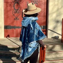 Load image into Gallery viewer, Upcycled from a collection of salvaged denim pants. Oversized hoodie, sprinkles of sashiko stitching, random pockets, a lots of intentional distress. Lightweight, with more denim for ties on the sides to be more fitting, or let loose and be more free flowing. A perfect layer of warm and fresh. 
Handcrafted with love and intention.
Upcycled Capelet Jacket
Urban vibes
One-of-a-kind
All size
Handmade in Santa Cruz, CA