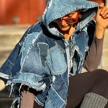 Load image into Gallery viewer, Upcycled from a collection of salvaged denim pants. Oversized hoodie, sprinkles of sashiko stitching, random pockets, a lots of intentional distress. Lightweight, with more denim for ties on the sides to be more fitting, or let loose and be more free flowing. A perfect layer of warm and fresh. 
Handcrafted with love and intention.
Upcycled Capelet Jacket
Urban vibes
One-of-a-kind
All size
Handmade in Santa Cruz, CA