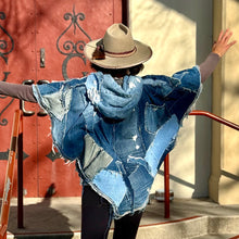 Load image into Gallery viewer, Upcycled from a collection of salvaged denim pants. Oversized hoodie, sprinkles of sashiko stitching, random pockets, a lots of intentional distress. Lightweight, with more denim for ties on the sides to be more fitting, or let loose and be more free flowing. A perfect layer of warm and fresh. 
Handcrafted with love and intention.
Upcycled Capelet Jacket
Urban vibes
One-of-a-kind
All size
Handmade in Santa Cruz, CA