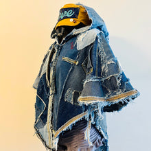 Load image into Gallery viewer, Upcycled from a collection of salvaged denim pants. Oversized hoodie, sprinkles of sashiko stitching, random pockets, a lots of intentional distress. Lightweight, with more denim for ties on the sides to keep a little fitted to your body. A perfect layer of warm and fresh. 
Handcrafted with love and intention.
Upcycled Capelet Jacket
Urban vibes
One-of-a-kind
All size
Handmade in Santa Cruz, CA