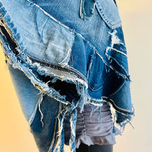 Load image into Gallery viewer, Upcycled from a collection of salvaged denim pants. Oversized hoodie, sprinkles of sashiko stitching, random pockets, a lots of intentional distress. Lightweight, with more denim for ties on the sides to keep a little fitted to your body. A perfect layer of warm and fresh. 
Handcrafted with love and intention.
Upcycled Capelet Jacket
Urban vibes
One-of-a-kind
All size
Handmade in Santa Cruz, CA