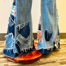 Load image into Gallery viewer, Upcycled from salvaged denim overalls, super colorful denim pants, and a lot of hand stitching and other denim scraps for embellishments and fun and unique detail. Base jeans are from American Rag Cie adult size 1 (XS/S adult), and in excellent condition! All intentional distress/rips that are significant have been also lined with fun fabric, so this piece is durable! Added amazing denim bits and pieces to create medium-flared bottoms. 