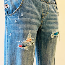 Load image into Gallery viewer, Upcycled from salvaged denim overalls, super colorful denim pants, and a lot of hand stitching and other denim scraps for embellishments and fun and unique detail. Base jeans are from American Rag Cie adult size 1 (XS/S adult), and in excellent condition! All intentional distress/rips that are significant have been also lined with fun fabric, so this piece is durable! Added amazing denim bits and pieces to create medium-flared bottoms. 