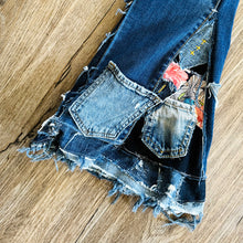 Load image into Gallery viewer, Upcycled from salvaged super stretch denim overalls, super colorful denim scraps, and hand stitching for added whimsy. More denim scraps as added embellishments and fun and unique detail. Base jeans are Cat & Jack, youth size 10/12, and in excellent condition! Intentional distress, fun denim bits and pieces fabric, this piece is super cute! Medium-flared bottoms. 