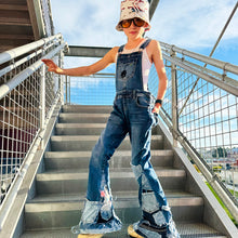 Load image into Gallery viewer, Upcycled from salvaged super stretch denim overalls, super colorful denim scraps, and hand stitching for added whimsy. More denim scraps as added embellishments and fun and unique detail. Base jeans are Cat & Jack, youth size 10/12, and in excellent condition! Intentional distress, fun denim bits and pieces fabric, this piece is super cute! Medium-flared bottoms. 