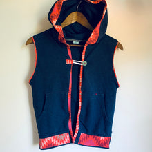 Load image into Gallery viewer, Upcycled from a tattered cotton adult hoodie, stretch cotton graphic cuts from Synergy Organic swatch samples, and a hand screen printed graphic patch by Shari Elf: &quot;Where are we going if we&#39;re not going to love&quot;.   Handcrafted with love and intention.   Upcycled spirit vest One-of-a-kind Size 9-11 youth Button and cord clasp Handmade in Santa Cruz, CA
