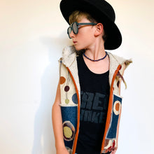 Load image into Gallery viewer, Upcycled from super fun upholstery scrap, lined with salvaged high end French Terry. Deep pockets in front and a backpack pocket in back made from remnant Selvedge Jean fabric. Oversized hoodie, button clasp, open neck for a cool breeze, and lots of whimsical detail.   * Owl not included. xoxo  Circles, and rectangles and lines OH MY Button clasp Comfortable layer of warmth - lined to keep your babe warm! One-of-a-kind Size 9-10 youth Handmade in Santa Cruz, CA Cold wash, hang dry