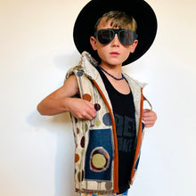 Load image into Gallery viewer, Upcycled from super fun upholstery scrap, lined with salvaged high end French Terry. Deep pockets in front and a backpack pocket in back made from remnant Selvedge Jean fabric. Oversized hoodie, button clasp, open neck for a cool breeze, and lots of whimsical detail.   * Owl not included. xoxo  Circles, and rectangles and lines OH MY Button clasp Comfortable layer of warmth - lined to keep your babe warm! One-of-a-kind Size 9-10 youth Handmade in Santa Cruz, CA Cold wash, hang dry
