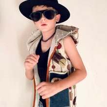 Load image into Gallery viewer, Upcycled from super fun upholstery scrap, lined with salvaged high end French Terry. Deep pockets in front and a backpack pocket in back made from remnant Selvedge Jean fabric. Oversized hoodie, button clasp, open neck for a cool breeze, and lots of whimsical detail.   * Owl not included. xoxo  Circles, and rectangles and lines OH MY Button clasp Comfortable layer of warmth - lined to keep your babe warm! One-of-a-kind Size 9-10 youth Handmade in Santa Cruz, CA Cold wash, hang dry