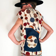 Load image into Gallery viewer, Upcycled from super fun upholstery scrap, lined with salvaged high end French Terry. Deep pockets in front and a backpack pocket in back made from remnant Selvedge Jean fabric. Oversized hoodie, button clasp, open neck for a cool breeze, and lots of whimsical detail.   * Owl not included. xoxo  Circles, and rectangles and lines OH MY Button clasp Comfortable layer of warmth - lined to keep your babe warm! One-of-a-kind Size 9-10 youth Handmade in Santa Cruz, CA Cold wash, hang dry