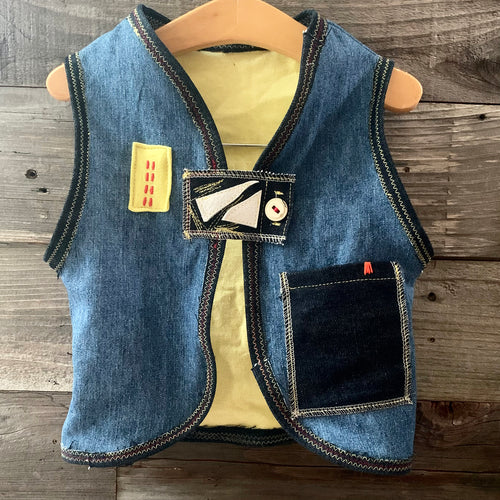 Upcycled from jeans, graphic tee, and salvaged embellishments. Lined with cotton tee. This cute vest is the perfect layer of warmth and love.   Handcrafted with love and intention.   Upcycled and one-of-a-kind Handmade in Santa Cruz, CA Size 2-3T I AM HAPPY 