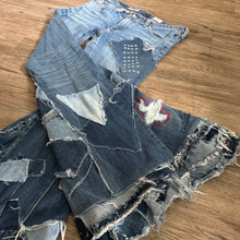 Load image into Gallery viewer, Upcycled from a collection of salvaged denim threads. Base jeans are from&nbsp;Adriano Goldshmied "The Stilt" womens size 28, and in excellent condition! Some give/stretch denim with intentional distress, and embroidered stitching over distressed areas. Added denim bits and pieces to create wide-flared bottoms.&nbsp;

Handcrafted with love and intention.

One-of-a-kind
Funky vibes
Size 28

Cold wash, like you would any pair of jeans, for longevity
Handmade in Santa Cruz, CA
