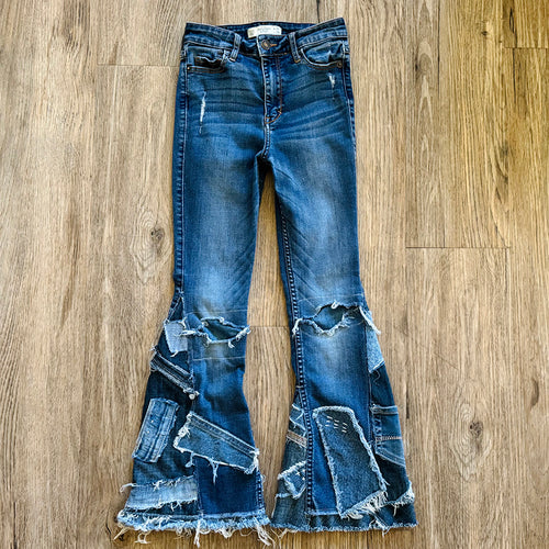 Upcycled from salvaged denim. Base jeans are from Abercrombie & Fitch Kids size 24 high rise (9/10), in great condition! Stretch denim with some intentional distress. Added denim bits and pieces, sashiko stitching for detail and embellishment, medium-flared bottoms. 

Handcrafted with love and intention.

One-of-a-kind
Fresh vibes
Size 24 kids (9/10)

Cold wash, like you would any pair of jeans, for longevity
Handmade in Santa Cruz, CA