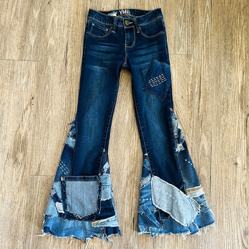 Upcycled from salvaged denim. Base jeans are from YMIGirl Kids size 7, in great condition! Stretch denim with some intentional distress. Added denim bits and pieces, sashiko stitching for detail and embellishment, medium-flared bottoms. 

Handcrafted with love and intention.

One-of-a-kind
Fresh vibes
Size 7

Cold wash, like you would any pair of jeans, for longevity
Handmade in Santa Cruz, CA