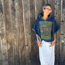 Load image into Gallery viewer, Upcycled from salvaged, super yummy, lightweight denim scraps, and a vintage Iranian tapestry. Lightweight and flowy, with oversized hoodie. Intentional raw edges, and revealed stitching, this beautiful poncho is perfectly imperfect and ready to be worn as another layer of love and flare.   Handcrafted with love and intention.  Upcycled poncho Vintage Iranian tapestry Denim patchwork vibes One-of-a-kind Oversized hooded poncho Handmade in Santa Cruz, CA
