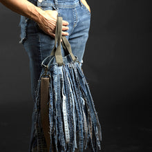 Load image into Gallery viewer, Upcycled from a whole lotta salvaged denim scraps, carefully sewn onto a salvaged denim bag with one interior pocket. This bag has both hand straps, as well as a shoulder strap for versatility! Not only are you choosing eco conscious with using textiles saved from the landfill, this bag is super unique and fly! DENIM DENIM DENIM!

Handcrafted with love and intention.

One-of-a-kind
Denim vibes

Handmade in Santa Cruz, CA
