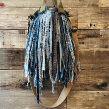 Load image into Gallery viewer, Upcycled from a whole lotta salvaged denim scraps, carefully sewn onto a salvaged denim bag with one interior pocket. This bag has both hand straps, as well as a shoulder strap for versatility! Not only are you choosing eco conscious with using textiles saved from the landfill, this bag is super unique and fly! DENIM DENIM DENIM!

Handcrafted with love and intention.

One-of-a-kind
Denim vibes

Handmade in Santa Cruz, CA
