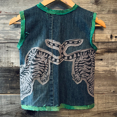 Upcycled from denim jeans, Sure Design cotton tee, and vintage specialty silk. Intentional distress, revealed stitching, pockets for treasures, with whimsical detail. 

Hand crafted with love and intention.

Denim and button clasp
One-of-a-kind
Size 8-9 youth
Cold wash
Handmade in Santa Cruz, CA