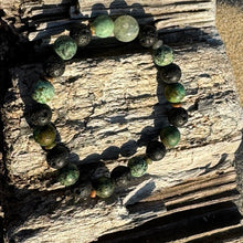 Load image into Gallery viewer, Center stone: Prehnite Associated to the heart chakra, opening the heart to unconditional love, healing emotional wounds, and promoting self-love and forgiveness.  African Turquoise: Supports the immune system, relieving pain and discomfort, and promote overall well-being. Stone of creativity, abundance and self-expression.  Lava Stone: A grounding stone that&nbsp;strengthens one&#39;s connection to mama earth.  Unakite (spacers):&nbsp;Assists with emotional healing, forgiveness, letting go.&nbsp;
