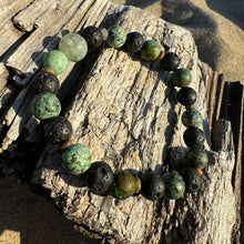 Load image into Gallery viewer, Center stone: Prehnite Associated to the heart chakra, opening the heart to unconditional love, healing emotional wounds, and promoting self-love and forgiveness.  African Turquoise: Supports the immune system, relieving pain and discomfort, and promote overall well-being. Stone of creativity, abundance and self-expression.  Lava Stone: A grounding stone that&nbsp;strengthens one&#39;s connection to mama earth.  Unakite (spacers):&nbsp;Assists with emotional healing, forgiveness, letting go.&nbsp;
