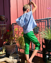 Load image into Gallery viewer, Upcycled from salvaged cotton blend dress, and an IRIECYCLE linocut block print patch on cotton tee for pocket. This fabric has a bit of stretch to it, so its perfect for play and movement! Cord waist string, revealed stitching for color and whimsy. Capris length vibes.&nbsp; &nbsp;
