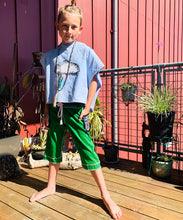 Load image into Gallery viewer, Upcycled from salvaged cotton blend dress, and an IRIECYCLE linocut block print patch on cotton tee for pocket. This fabric has a bit of stretch to it, so its perfect for play and movement! Cord waist string, revealed stitching for color and whimsy. Capris length vibes.&nbsp; &nbsp;
