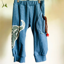 Load image into Gallery viewer, Upcycled from a super soft L.L. Bean cotton blend robe, and a graphic tee. These pants are made for play, incredibly soft and not to thin that a hole will appear in a little fall. Perfect lightweight layer of love on your little one&#39;s bottoms!  Handcrafted with love and intention.  One-of-a-kind Size 2T  Cow skull vibes Side pocket for special treasures Handmade in Santa Cruz, CA
