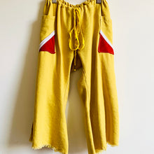 Load image into Gallery viewer, &lt;p&gt;Upcycled from yellow denim cotton adult skirt, and cotton hoodies. Cord tie waistband, adjustable and can be worn as long pants for small size, and as capris for bigger size. Side slits at bottoms on pant legs for flowy vibes, and two pockets for all the magical treasures.&nbsp; &nbsp;&lt;br&gt;Handcrafted with love and intention.&lt;/p&gt; &lt;ul&gt; &lt;li&gt;Handmade in Santa Cruz, CA&lt;/li&gt; &lt;li&gt;One-of-a-kind&lt;/li&gt; &lt;li&gt;Soft denim cotton&lt;/li&gt; &lt;li&gt;Size 3-5T&lt;/li&gt; &lt;li&gt;Sunshine vibes&lt;/li&gt; &lt;/ul&gt;
