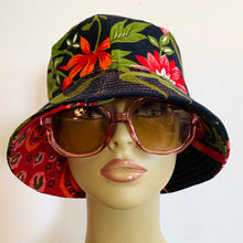 Load image into Gallery viewer, Indian dress upcycled into this reversible bucket hat. Each side uses different parts of the garmet, so that each has its own vibe - one with butterfly and flowers, the other tiger and tiger abstract spots. Midweight interfacing so the brim is a bit stiffer on this one.
