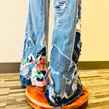 Load image into Gallery viewer, Upcycled from salvaged denim overalls, super colorful denim pants, and a lot of hand stitching and other denim scraps for embellishments and fun and unique detail. Base jeans are from&nbsp;American Rag Cie adult size 1 (XS/S adult), and in excellent condition! All intentional distress/rips that are significant have been also lined with fun fabric, so this piece is durable! Added amazing denim bits and pieces to create medium-flared bottoms.&nbsp;
