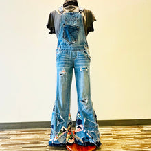 Load image into Gallery viewer, Upcycled from salvaged denim overalls, super colorful denim pants, and a lot of hand stitching and other denim scraps for embellishments and fun and unique detail. Base jeans are from&nbsp;American Rag Cie adult size 1 (XS/S adult), and in excellent condition! All intentional distress/rips that are significant have been also lined with fun fabric, so this piece is durable! Added amazing denim bits and pieces to create medium-flared bottoms.&nbsp;
