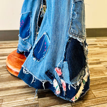 Load image into Gallery viewer, Upcycled from salvaged denim overalls, super colorful denim pants, and a lot of hand stitching and other denim scraps for embellishments and fun and unique detail. Base jeans are from&nbsp;American Rag Cie adult size 1 (XS/S adult), and in excellent condition! All intentional distress/rips that are significant have been also lined with fun fabric, so this piece is durable! Added amazing denim bits and pieces to create medium-flared bottoms.&nbsp;
