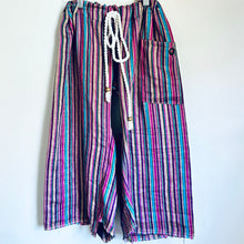 Load image into Gallery viewer, Upcycled from vintage remnant, and salvaged cord and beads, this piece is wide legged and flowy, and versatile in size with adjustable cord. Striped with lively colors, capris length vibes. Perfect for summertime fun!&nbsp;&nbsp;  Handcrafted with love and intention.&nbsp;  Handmade in Santa Cruz, CA One-of-a-kind Size 6-10 youth (fits longer for smaller sizes, capris length for bigger babes!) Cold wash, hang dry
