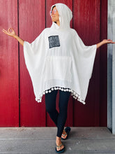 Load image into Gallery viewer, Upcycled from remnant gauze cotton, salvaged dingle balls, and a lino block print patch by IRIECYCLE: &quot;I am a Whole Universe&quot;, because you are.  Handcrafted with love and intention.  Upcycled poncho One-of-a-kind Oversized hoody  Conscious vibes ALL SIZE Handmade in Santa Cruz, CA
