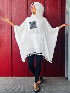 Upcycled from remnant gauze cotton, salvaged dingle balls, and a lino block print patch by IRIECYCLE: "I am a Whole Universe", because you are.  Handcrafted with love and intention.  Upcycled poncho One-of-a-kind Oversized hoody  Conscious vibes ALL SIZE Handmade in Santa Cruz, CA