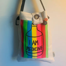 Load image into Gallery viewer, Upcycled from a cotton canvas duck adult sleeve and an &quot;I AM MEDICINE&quot; hand printed graphic patch by Shari Elf, and salvaged belt (as strap) buttons. We are all our own medicine if you tune in.   One-of-a-kind Shoulder tote bag Over-the-shoulder bag Handmade in Santa Cruz, CA I AM MEDICINE vibes
