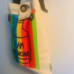 Upcycled from a cotton canvas duck adult sleeve and an "I AM MEDICINE" hand printed graphic patch by Shari Elf, and salvaged belt (as strap) buttons. We are all our own medicine if you tune in.   One-of-a-kind Shoulder tote bag Over-the-shoulder bag Handmade in Santa Cruz, CA I AM MEDICINE vibes