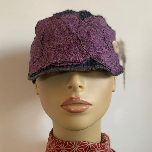 One of a kind design elements and embellishments upcycled from salvaged remnant fabric scraps, and hand sewn in Santa Cruz, CA. 100% cotton cap, handmade in Bali.   Purple drops vibes   Purple blue colored ribbed cap Button and feather embellishments 100% cotton US size 7 1/2