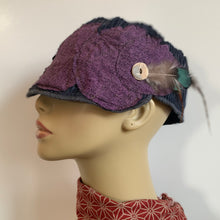 Load image into Gallery viewer, One of a kind design elements and embellishments upcycled from salvaged remnant fabric scraps, and hand sewn in Santa Cruz, CA. 100% cotton cap, handmade in Bali.   Purple drops vibes   Purple blue colored ribbed cap Button and feather embellishments 100% cotton US size 7 1/2&quot; *  Wash cold, hang dry *see size chart for detailed measurement
