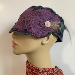 One of a kind design elements and embellishments upcycled from salvaged remnant fabric scraps, and hand sewn in Santa Cruz, CA. 100% cotton cap, handmade in Bali.   Purple drops vibes   Purple blue colored ribbed cap Button and feather embellishments 100% cotton US size 7 1/2" *  Wash cold, hang dry *see size chart for detailed measurement