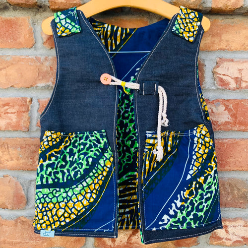 Upcycled from selvedge jean scrap and African remnant fabric. Lined for warmth and durability, with two pockets for all those found magical treasures. This spirit vest is lightweight yet made for play and fun flare. A perfect colorful and eclectic layer of love!   Handcrafted with love and intention.   Upcycled and one-of-a-kind Button and cord clasp Lined and with two front pockets  Lightweight Handmade in Santa Cruz, CA Cold wash, hang dry