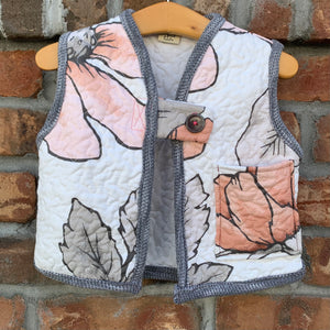 Upcycled from a vintage quilt and cotton ribbed top. Super amazing fabric and salvaged large button. This spirit vest is lightweight and a sweet layer of love!   Handcrafted with love and intention.   Upcycled and one-of-a-kind Button and fabric clasp A little pocket for treasures Lightweight Handmade in Santa Cruz, CA Cold wash, hang dry